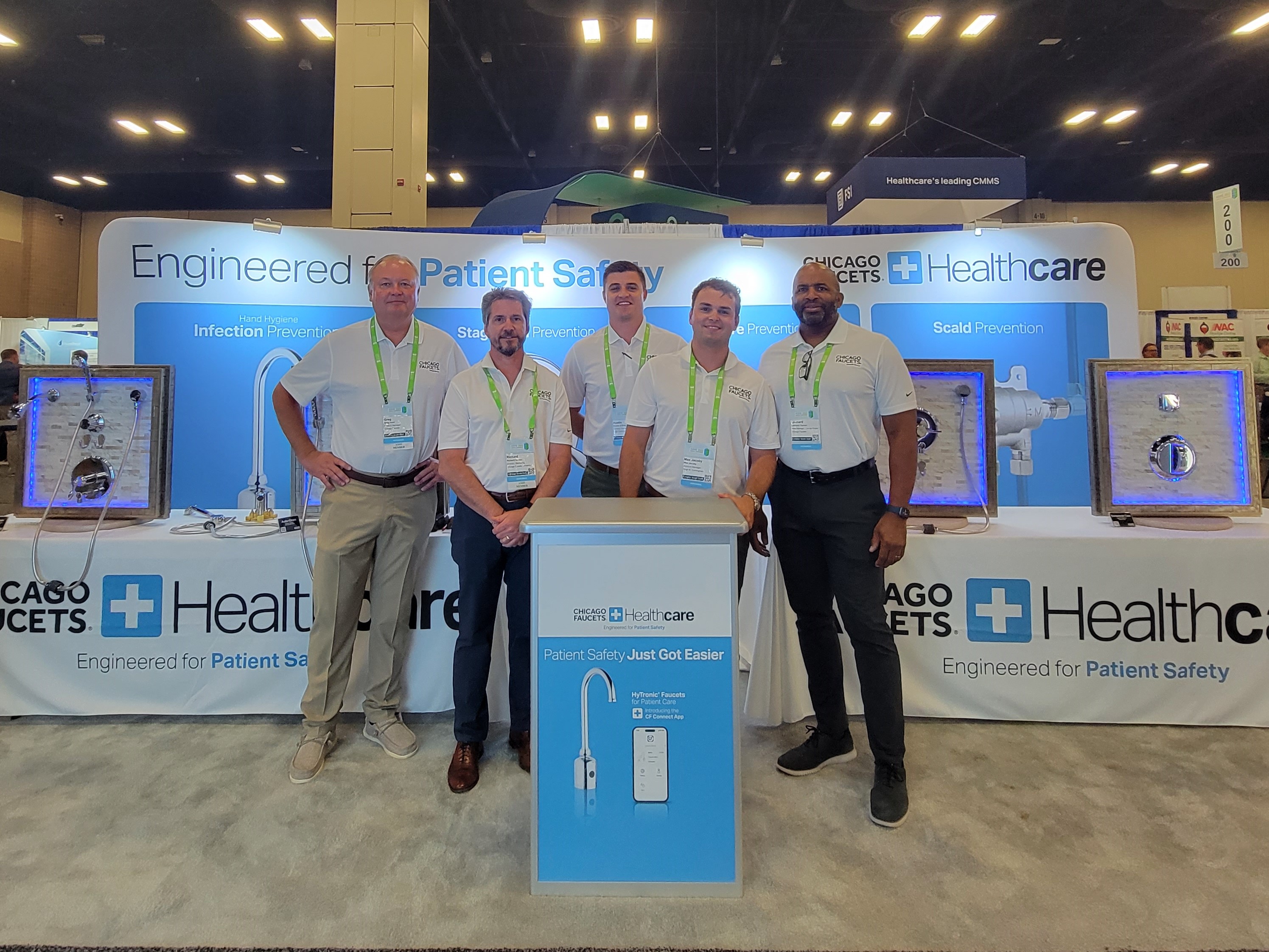 booth staff standing at Chicago Faucets + Healthcare booth